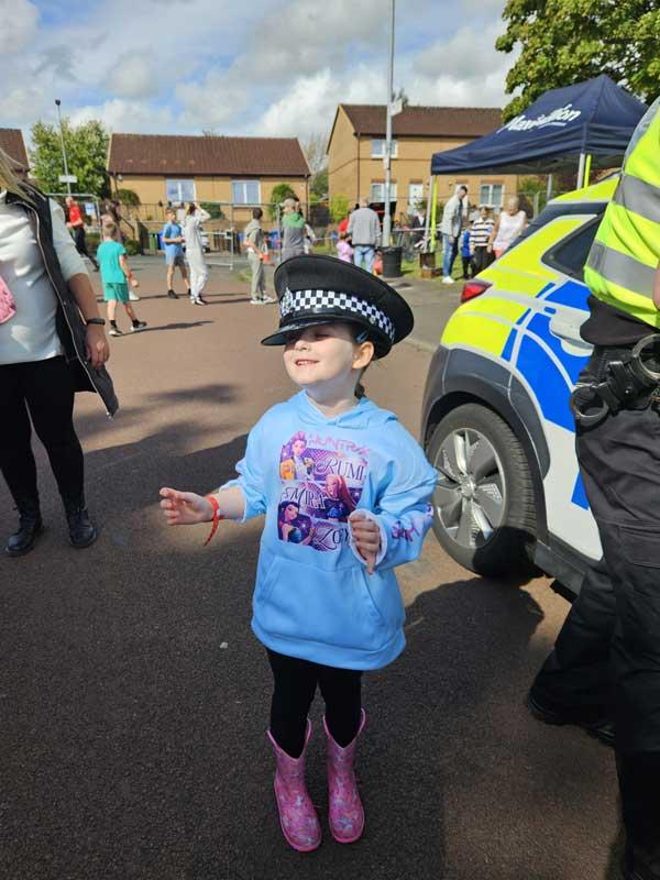 Childr Wearing Police Hat At Fun Day