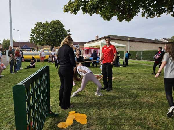 Children Doing The Limbo At Fun Day